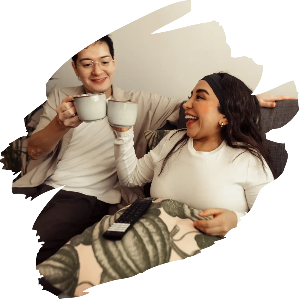 Disabled woman and man clinking mugs at home and smiling